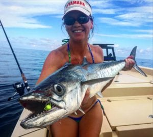 An angler catching a kingfish on a nearshore fishing charter out of charlotte harbor